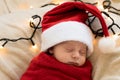 Top View Portrait First Days Of Life Newborn Cute Funny Sleeping Child Baby In Santa Hat Wrapped In Red Diaper At White Royalty Free Stock Photo
