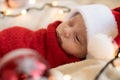 Top View Portrait First Days Of Life Newborn Cute Funny Sleeping Child Baby In Santa Hat Wrapped In Red Diaper At White Royalty Free Stock Photo