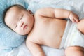 Top view Portrait of a newborn Asian cute baby boy wore blue Infant bodysuit on the bed , Charming Fat baby 5 month old lies in Royalty Free Stock Photo