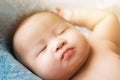 Top view Portrait of a newborn Asian cute baby boy wore blue Infant bodysuit on the bed , Charming Fat baby 5 month old lies in Royalty Free Stock Photo