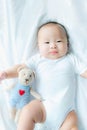 Top view Portrait of a newborn Asian cute baby boy wore white Infant bodysuit on the bed , Charming Fat baby 5 month old lies in Royalty Free Stock Photo