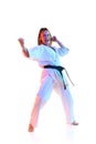 Top view portrait of woman, Taekwondo teacher performing high kick isolated over white studio background. Royalty Free Stock Photo