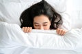 Top view of portrait young of beautiful Asian woman sleep on the white bed under blanket in the modern bedroom Royalty Free Stock Photo