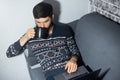 Top view portrait of young man, sitting home on sofa, drinking coffee and looking surprised in laptop. Royalty Free Stock Photo