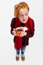 Top view portrait of young sick girl, having cold and flue, drinking herbal tea isolated over white background Royalty Free Stock Photo