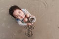 Top view portriat Asian little girl playing on the sand beach wi