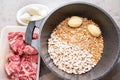 Top view of pot with potato, beans, wheat grains, pearl barley and spices on a grey marble kitchen table. Preparing food Royalty Free Stock Photo