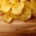Top view potato chips over wooden table