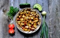 Top view of potatoes baked with spices and fresh vegetables: tomatoes, cucumbers, onions, parsley and dill on a wooden background Royalty Free Stock Photo