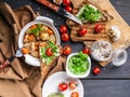 Top view potatoes with chicken and vegetables, sandwiches with cheese and cherry tomatoes on a dark wooden background