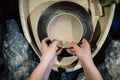 Top view, potter hands makes ceramic pot