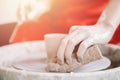 Top view of the potter wheel, hands of young woman make ceramic dishes from clay Royalty Free Stock Photo