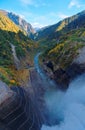 Top view of powerful water discharge from a dam into a beautiful gorge in Tateyama Kurobe Alpine Route
