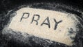 Top view of PRAY text written on white sand Royalty Free Stock Photo