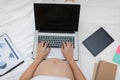 Top view of Pregnant business woman sitting and working on the laptop with sale report,tablet,books and sticky note at home, Royalty Free Stock Photo