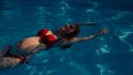 Top view of pregnant woman floating in pool in red bikini. Royalty Free Stock Photo