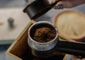 Top view on the preparation of fresh ground coffee in a coffee maker