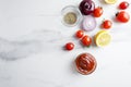 Top view of preparation of tomato sauce,ketchup with different ingredients on white marble table Royalty Free Stock Photo