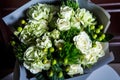 Top view on pretty exquisite bouquet of big white roses and fresh greenery Royalty Free Stock Photo