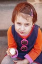 Top view of pretty little child girl eating ice cream outdoors food, dessert, childhood, satisfaction, carelessness concept Royalty Free Stock Photo