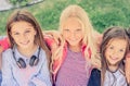 Top view of Pretty smiling little girls sit hugging together