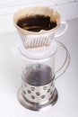 Top view the process of brewing ground coffee in a funnel v60 and draining it into a vessel, top view Royalty Free Stock Photo