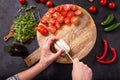 Top view of the process of preparing fresh vegetable salad with mozzarella cheese on a wooden chopping board Royalty Free Stock Photo