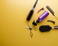 Top view of professional hair dresser tools on yellow