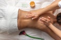 Top view professional masseuse performing with hand back massage to young woman client in wellness spa center, beauty photo Royalty Free Stock Photo