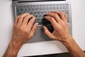 Top view of programmer male typing code on laptop keyboard, showcasing process of software development and coding Royalty Free Stock Photo