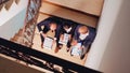 Top view of project team looking on documents sitting on stairs Royalty Free Stock Photo