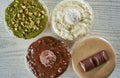 Top view of puddings in four cups covered with creams having different tastes Royalty Free Stock Photo