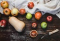 top view of pumpkin, apples, blood oranges, kitchen towel and knife Royalty Free Stock Photo