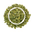 Top view of pumpkin seeds in white bowl isolated on white Royalty Free Stock Photo