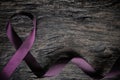 Top view of purple ribbon on wood background with copy space. Pancreatic cancer, epilepsy, leiomyosarcoma, lupus, Alzheimer`s
