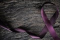 Top view of purple ribbon on wood background with copy space. Pancreatic cancer, epilepsy, leiomyosarcoma, lupus, Alzheimer`s