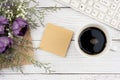 Purple tulip and a blank sticky note on cup of coffee background Royalty Free Stock Photo