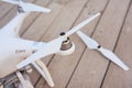 Top view of quadrocopter landed on wooden surface. Selective focus at the propeller