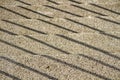 Top view of railing shadows on concrete stairs on a sunny day Royalty Free Stock Photo