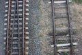 Top view of railway tracks in the countryside. Close-up of the railroad. Rusty iron train railway detail on gravel background Royalty Free Stock Photo