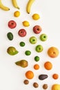 Top view of rainbow composition of various colorful fresh fruits isolated over white background