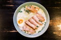 Top view of Ramen Cream Pork Bone Soup Tonkotsu Ramen with Chashu Pork, Scallion, Sprout, Onion, Menma and Dried Seaweed.