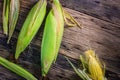 Top view raw corn On old wooden table. Royalty Free Stock Photo