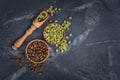 Top view of raw green unroasted and brown roasted coffee beans in wooden bowls and scoop Royalty Free Stock Photo