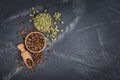 Top view of raw green unroasted and brown roasted coffee beans in wooden bowls and scoop Royalty Free Stock Photo