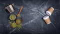 Top view of raw green unroasted ground beans with geyser coffee maker and disposable take-out cups Royalty Free Stock Photo