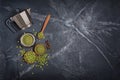 Top view of raw green unroasted ground beans with geyser coffee maker and wooden spoon