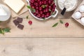 Top view raw ingredients for cooking cherry pie on wooden background with copy space. Bakery background Royalty Free Stock Photo