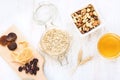 Top view of raw ingredients for homemade granola preparation - oats, nuts, honey and dried fruits. Healthy eating Royalty Free Stock Photo