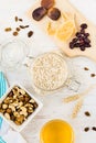 Top view of raw ingredients for homemade granola preparation - oats, nuts, honey and dried fruits. Healthy eating Royalty Free Stock Photo